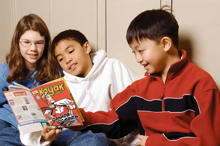 This image shows children reading an issue of Kayak: Canada's History Magazine for Kids