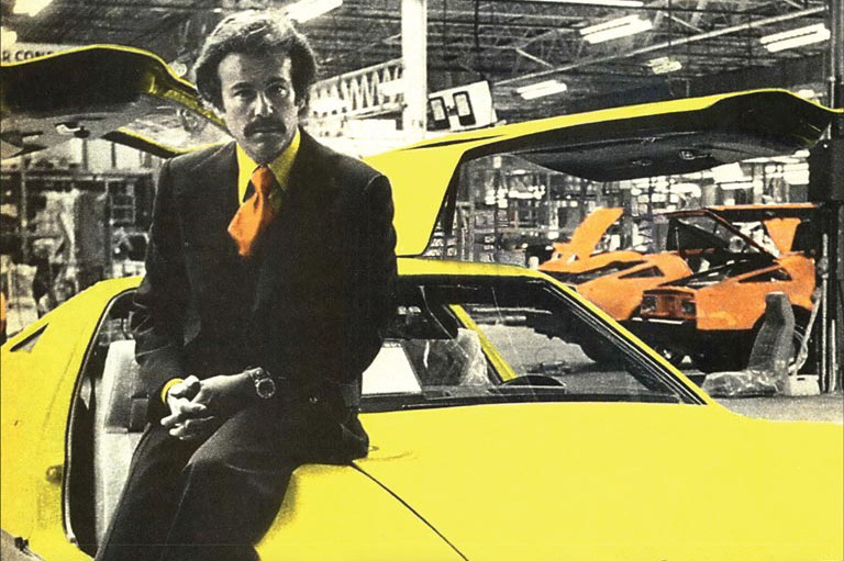 Cover of Dream Car showing Malcolm Bricklin leaning against a yellow 1970s-era Safety Vehicle-1 (SV1).