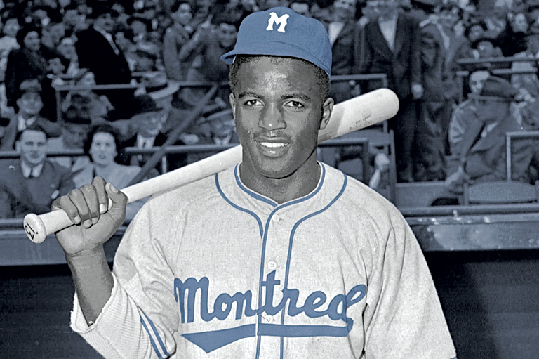 Black & white photo of Jackie Robinson holding a bat behind his neck